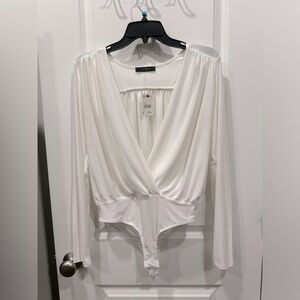 White low cut bodysuit. Never been worn and tag still on!